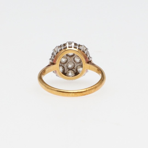 969 - A DIAMOND CLUSTER RING. millegrain set with graduated round old-cut diamonds, in 18ct gold and plati... 