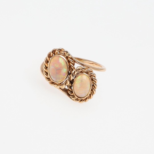 972 - AN OPAL AND GOLD DOUBLE CLUSTER RING. mounted with two oval-shaped solid white opals, in 18ct yellow... 