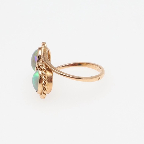 972 - AN OPAL AND GOLD DOUBLE CLUSTER RING. mounted with two oval-shaped solid white opals, in 18ct yellow... 