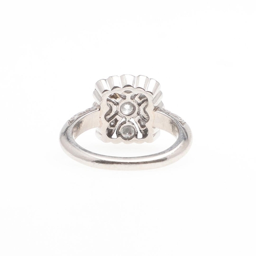 975 - A DIAMOND CLUSTER RING. of openwork flowerhead design, set with circular-cut diamonds, in platinum, ... 