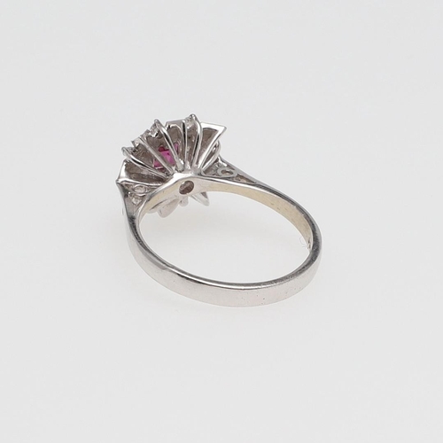 978 - A SPINEL AND DIAMOND CLUSTER RING. the square-shaped pink spinel is set within a surround of circula... 