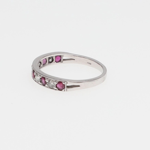 980 - A RUBY AND DIAMOND HALF HOOP RING. mounted alternately with circular-cut rubies and diamonds, in 18c... 