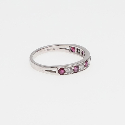 980 - A RUBY AND DIAMOND HALF HOOP RING. mounted alternately with circular-cut rubies and diamonds, in 18c... 