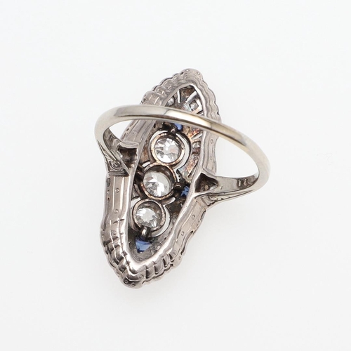 981 - A SAPPHIRE AND DIAMOND CLUSTER RING. the lozenge-shaped ring is mounted with three collet-set circul... 