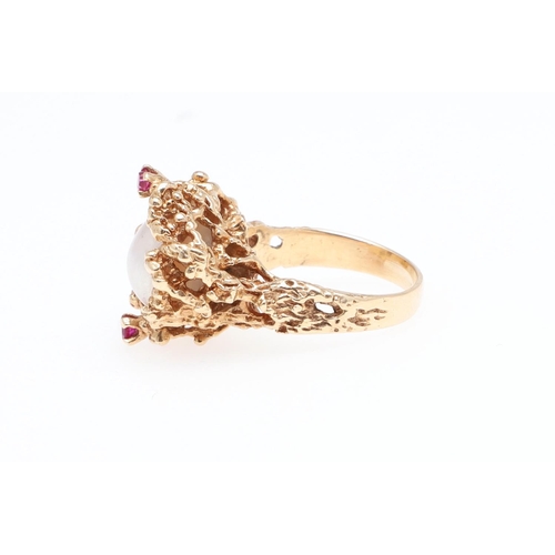 988 - A CULTURED PEARL, RUBY AND GOLD DRESS RING. the cultured pearl is set within a 14ct gold openwork te... 