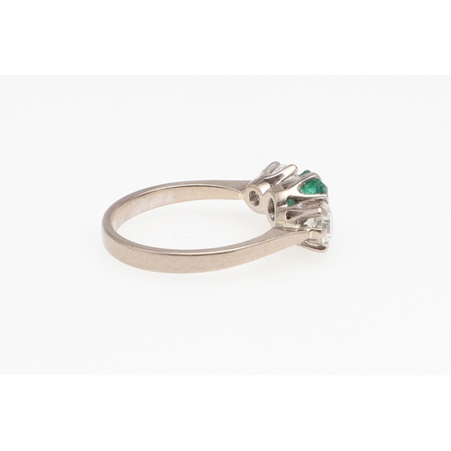 993 - AN EMERALD AND DIAMOND THREE STONE RING. the rectangular-shaped emerald  is set with two brilliant-c... 