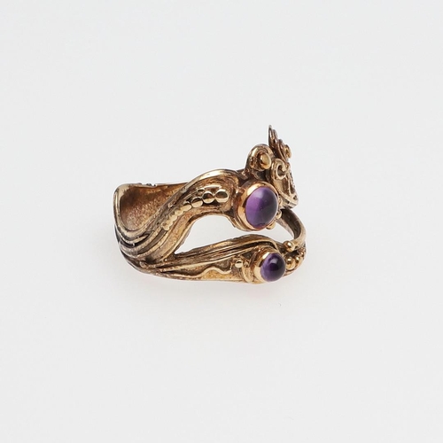 995 - AN AMETHYST AND 9CT GOLD 'NEPTUNE' RING BY LUCY COPLESTONE. mounted with a circular cabochon amethys... 