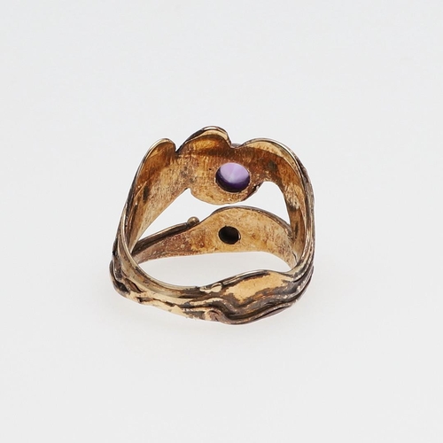 995 - AN AMETHYST AND 9CT GOLD 'NEPTUNE' RING BY LUCY COPLESTONE. mounted with a circular cabochon amethys... 