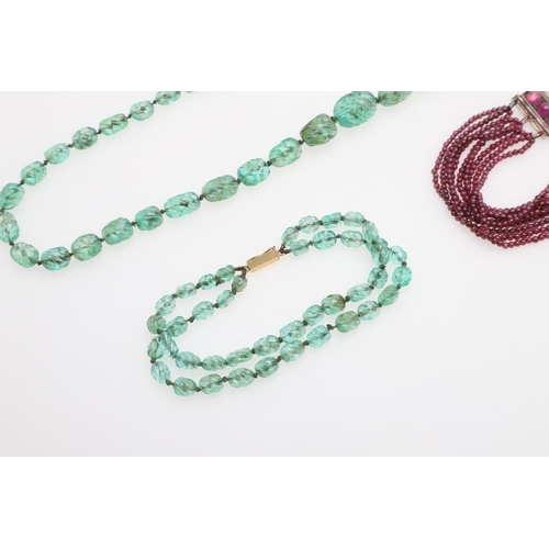 998 - A SINGLE ROW GRADUATED EMERALD BEAD NECKLACE. mounted with carved irreqular-shaped emerald beads, to... 