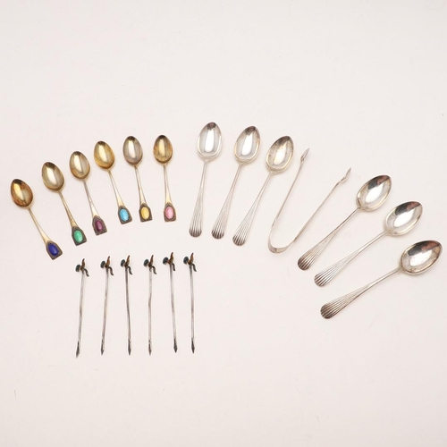 100 - THREE CASED SETS. a George V cased set of six silvergilt teaspoons, with beaded & enamelled terminal... 