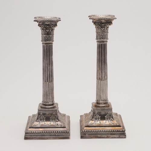 117 - A PAIR OF LATE VICTORIAN CANDLESTICKS. in the form of Corinthian columns, with bead borders and deta... 