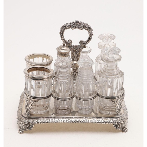 123 - A GEORGE IV RECTANGULAR CRUET FRAME. with rounded corners, a central loop handle, acanthus leaf supp... 