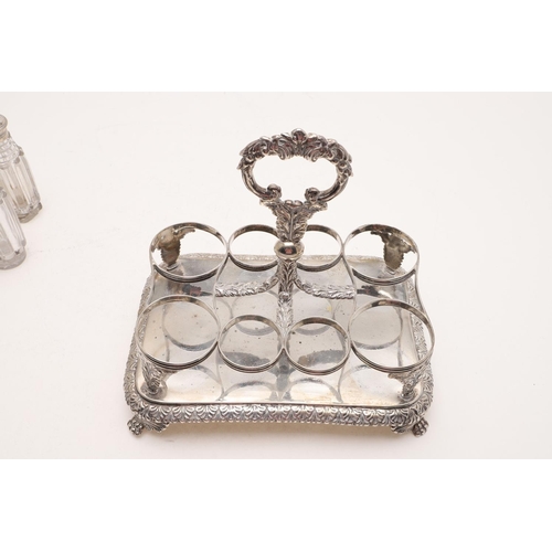 123 - A GEORGE IV RECTANGULAR CRUET FRAME. with rounded corners, a central loop handle, acanthus leaf supp... 