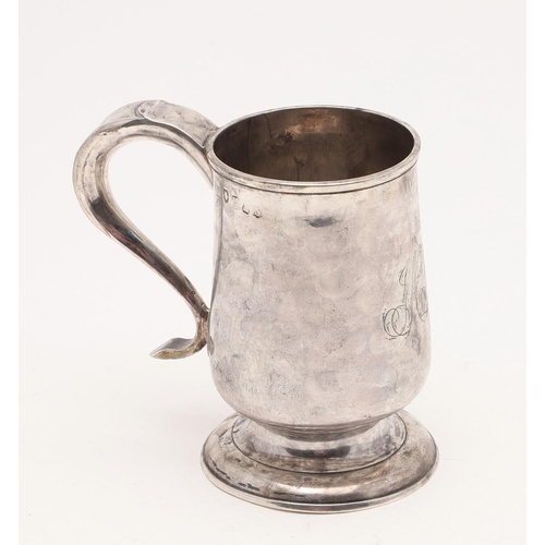 124 - A GEORGE III NORTH-COUNTRY PROVINCIAL MUG. baluster form, with a scroll handle and on a spreading ci... 