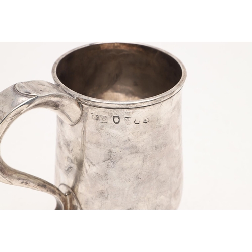 124 - A GEORGE III NORTH-COUNTRY PROVINCIAL MUG. baluster form, with a scroll handle and on a spreading ci... 