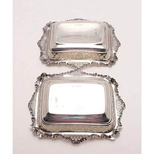 131 - A PAIR OF LATE VICTORIAN BONBON DISHES. rectangular form, with pierced sides and foliate scroll bord... 