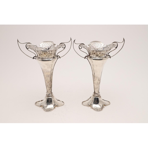 143 - A PAIR OF EDWARDIAN ART-NOUVEAU VASES. on shaped, domed bases with pierced and shaped rims and twin ... 