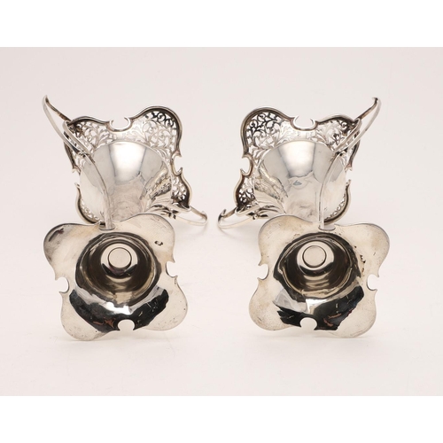 143 - A PAIR OF EDWARDIAN ART-NOUVEAU VASES. on shaped, domed bases with pierced and shaped rims and twin ... 