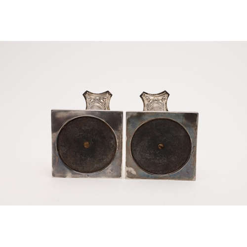 149 - A PAIR OF VICTORIAN CANDLESTICKS. on bevelled square bases (loaded), with fluted columns, bead borde... 