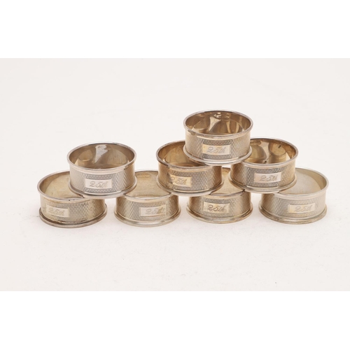 155 - A CASED SET OF SIX MODERN NAPKIN RINGS. with engine-turned decoration, each inscribed 