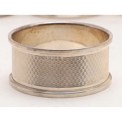 155 - A CASED SET OF SIX MODERN NAPKIN RINGS. with engine-turned decoration, each inscribed 