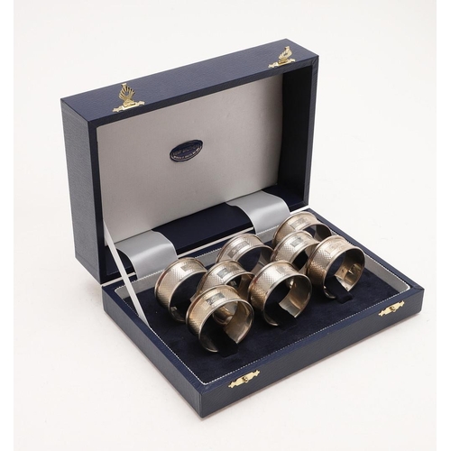 155 - A CASED SET OF SIX MODERN NAPKIN RINGS. with engine-turned decoration, each inscribed 