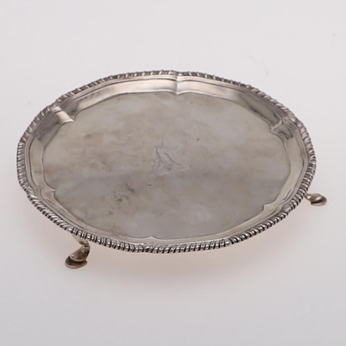 167 - A GEORGE III WAITER. of shaped circular outline, with a gadrooned border, engraved in the centre wit... 