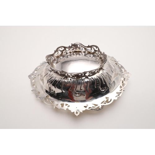 173 - A VICTORIAN SWING-HANDLED CAKE BASKET. shaped oval outline, with repoussÃ© decoration in the centre ... 