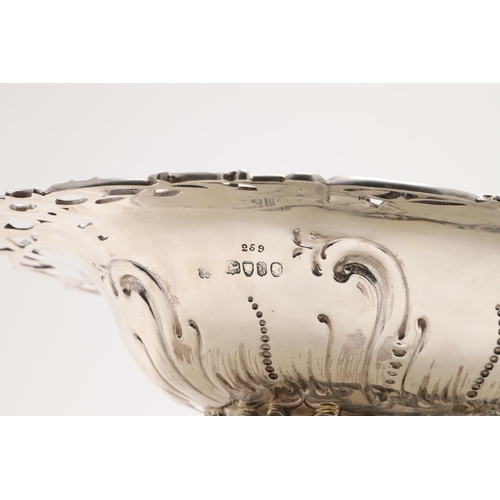 173 - A VICTORIAN SWING-HANDLED CAKE BASKET. shaped oval outline, with repoussÃ© decoration in the centre ... 