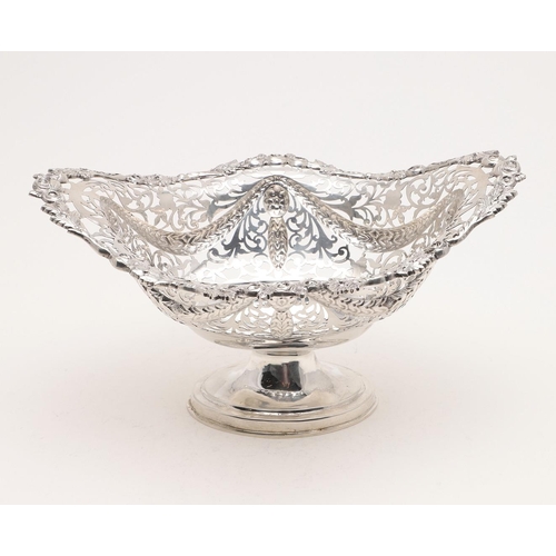 174 - A GEORGE V PEDESTAL BASKET. shaped oval outline, with pierced sides, embossed with festoons and with... 