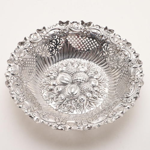 176 - A LATE VICTORIAN CIRCULAR FRUIT BASKET. with a wavy border, pierced sides and the centre decorated w... 