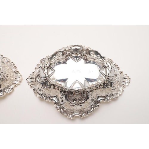 181 - A PAIR OF EDWARDIAN BASKETS. shaped oval outline, with pierced sides, a foliate scrolling border and... 