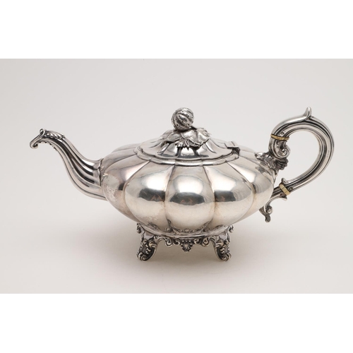 187 - A VICTORIAN IRISH TEA POT. of melon fluted form, with a strawberry finial, a 'C'-scroll handle and r... 