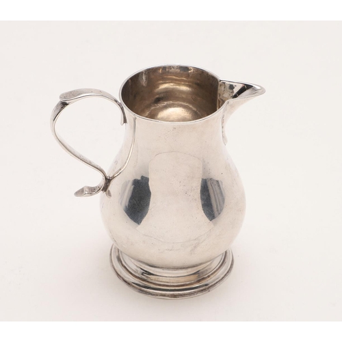 192 - A GEORGE V SPARROW-BEAK CREAM JUG. with a baluster body, a spreading circular foot and a scroll hand... 