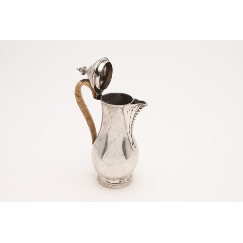 210 - A GEORGE III HOT WATER JUG. baluster form, with a cane insulated handle and an urn finial, by Peter ... 