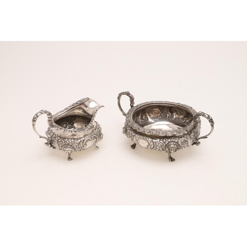 219 - A WILLIAM IV IRISH TWO-HANDLED SUGAR BOWL & MATCHING MILK JUG. squat circular form, with applied fol... 