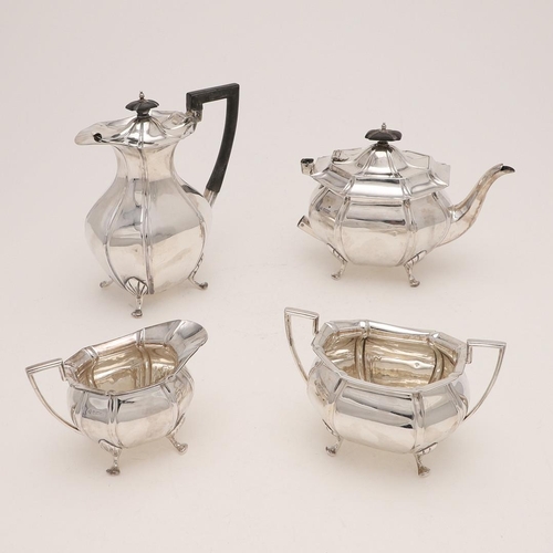 230 - A GEORGE V FOUR-PIECE TEA SET. of octagonal form, with angular handles and raised on four legs, by A... 