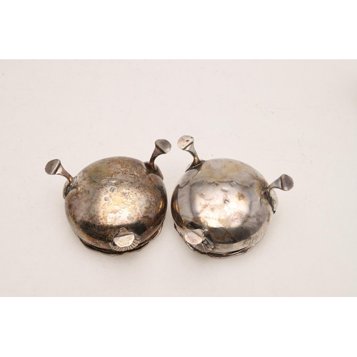 232 - A PAIR OF LATE GEORGE II CIRCULAR SALTS. with textured rims and on three legs, initialled, by Edward... 