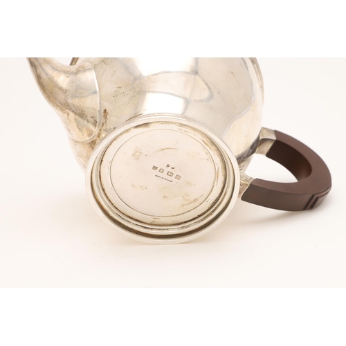 238 - A GEORGE VI CIRCULAR TEAPOT. with a scroll handle, a turned finial and a 