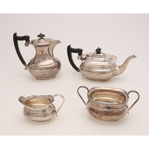 241 - A GEORGE V FOUR-PIECE TEA SET. with rounded oblong bodies, engraved decoration and scroll handles, b... 