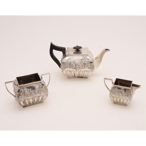 242 - A VICTORIAN THREE-PIECE TEA SET. of rectangular cushion form, with fluted lower bodies and embossed ... 