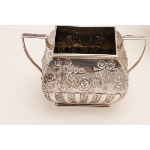 242 - A VICTORIAN THREE-PIECE TEA SET. of rectangular cushion form, with fluted lower bodies and embossed ... 