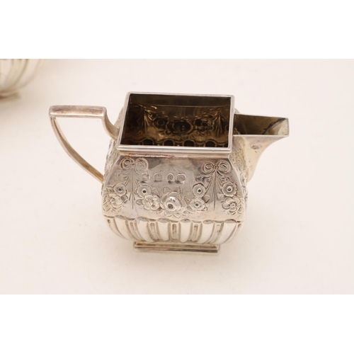 242 - A VICTORIAN THREE-PIECE TEA SET. of rectangular cushion form, with fluted lower bodies and embossed ... 