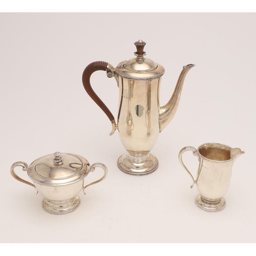 250 - A 20TH CENTURY THREE-PIECE COFFEE SET. of waisted form, with scroll handles, circular feet and appli... 