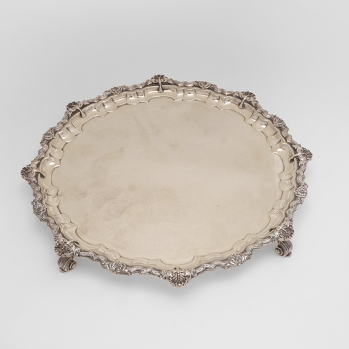 253 - A MID-20TH CENTURY SALVER. of shaped circular outline, with an applied border of alternating shells ... 