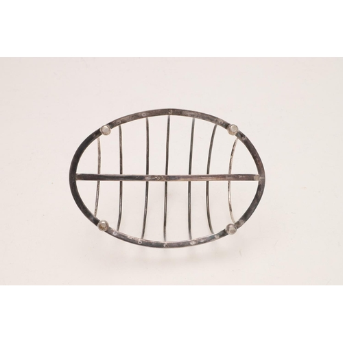 267 - A GEORGE III OVAL TOAST RACK. with seven arched bars, a central crescent handle and raised on four l... 