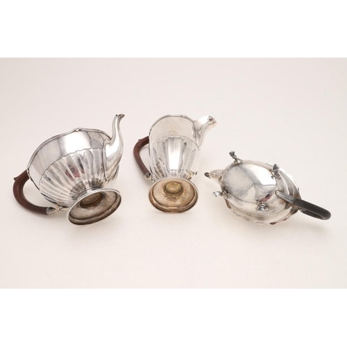 275 - A GEORGE V TEAPOT & MATCHING HOT WATER JUG. circular form, with fluted lower bodies, reeded borders ... 