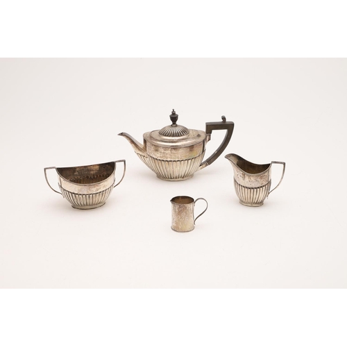 277 - A GEORGE V THREE-PIECE TEA SET. oval form, with fluted lower bodies & angular handles, by Goldsmiths... 