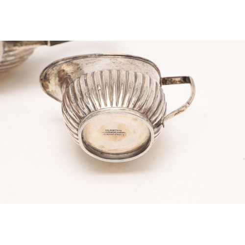 277 - A GEORGE V THREE-PIECE TEA SET. oval form, with fluted lower bodies & angular handles, by Goldsmiths... 