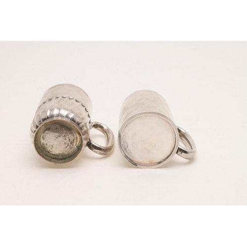 280 - TWO 20TH CENTURY SILVER MUGS. one with a fluted lower body and a collet foot, by William Hutton & So... 